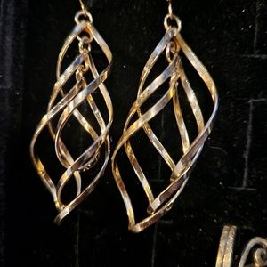 Dangling gold twisty earrings. Very cool power broker jewelry.